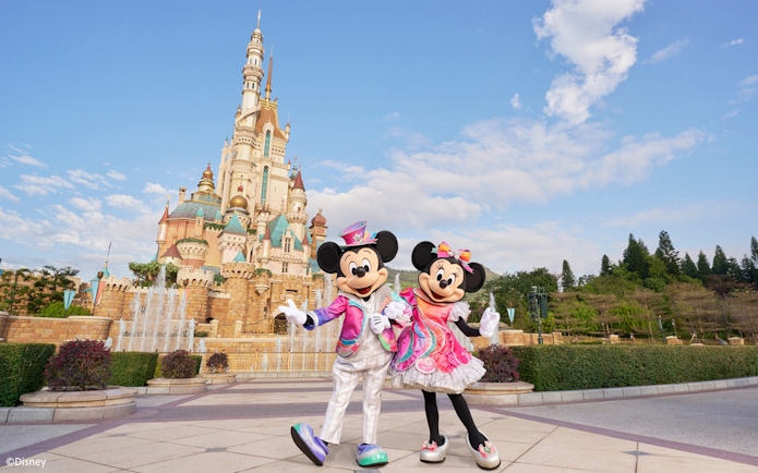 Mickey and Minnie Mouse in front of the castle at Disneyland Hong Kong.