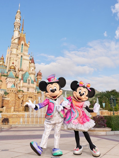 Mickey and Minnie Mouse in front of the castle at Disneyland Hong Kong.