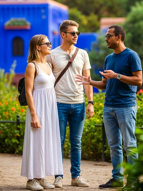 Guide explaining to tourists in Jardin Majorelle, Marrakech.