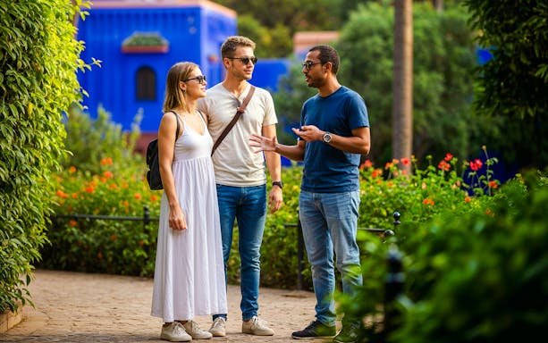 Guide explaining to tourists in Jardin Majorelle, Marrakech.
