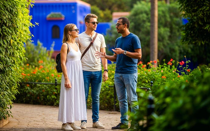 Guide explaining to tourists in Jardin Majorelle, Marrakech.