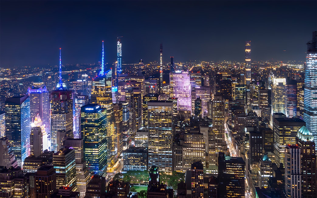 New York City skyline illuminated at night during Big Bus Night Tour.