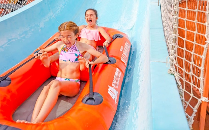 Two children enjoying the Master Blaster water ride at Schlitterbahn New Braunfels.