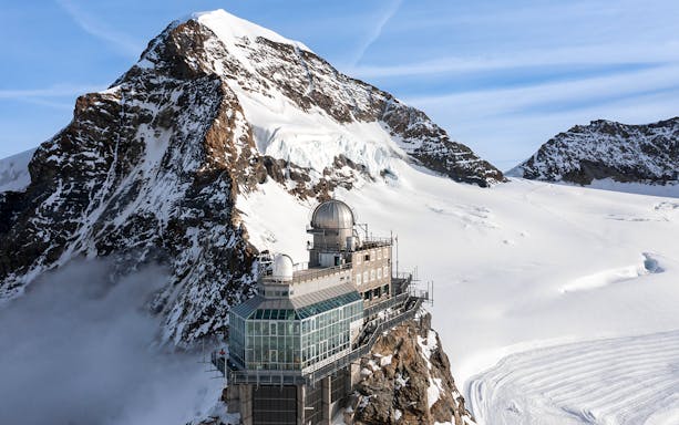 Sphinx Observatory on Jungfraujoch with snowy mountain backdrop, Switzerland.