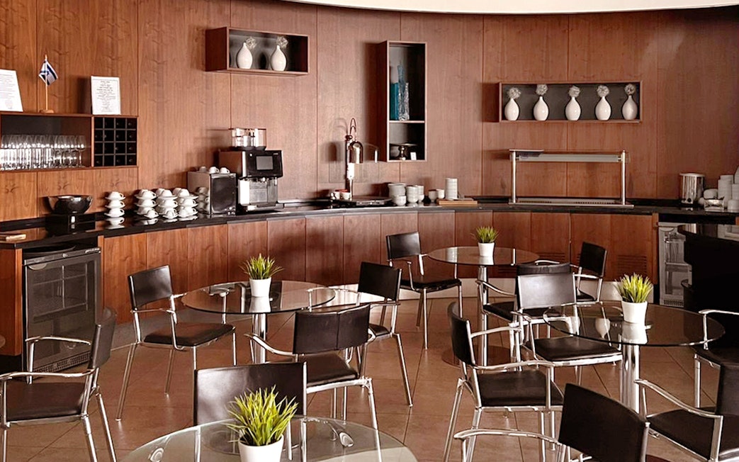 Blush Lounge seating area with tables and chairs, Terminal 4, London Heathrow Airport.