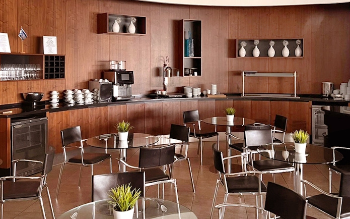 Blush Lounge seating area with tables and chairs, Terminal 4, London Heathrow Airport.