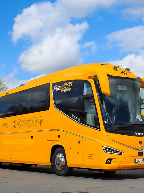 RegioJet bus parked in Prague under a blue sky.