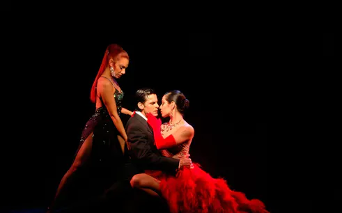 Tango dancers performing at Rojo Tango Show in Buenos Aires.