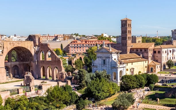 Roman Forum ruins with Basilica of Maxentius and bell tower, Rome, Italy.