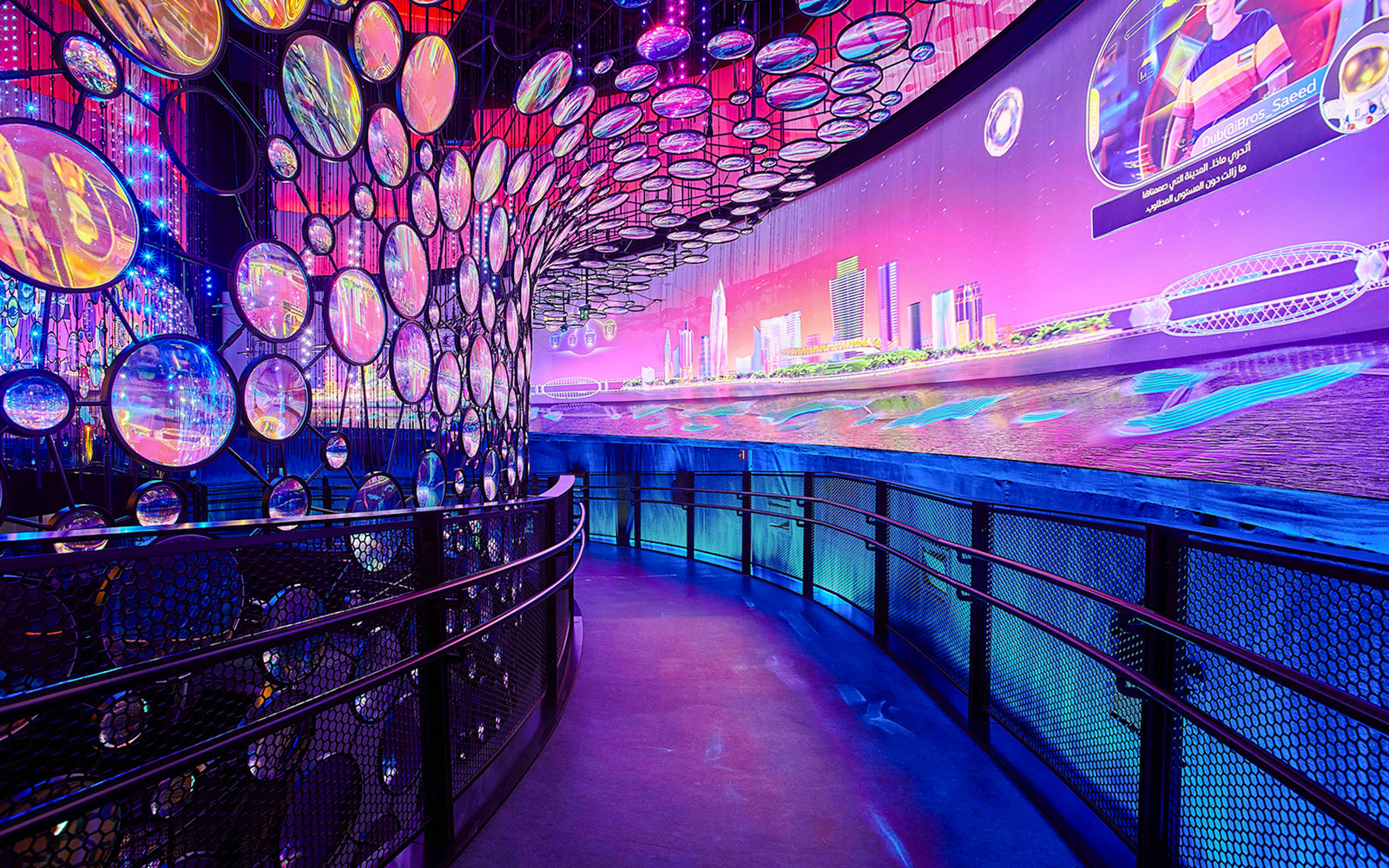 Exhibit with colorful lights and cityscape at Expo City Dubai.