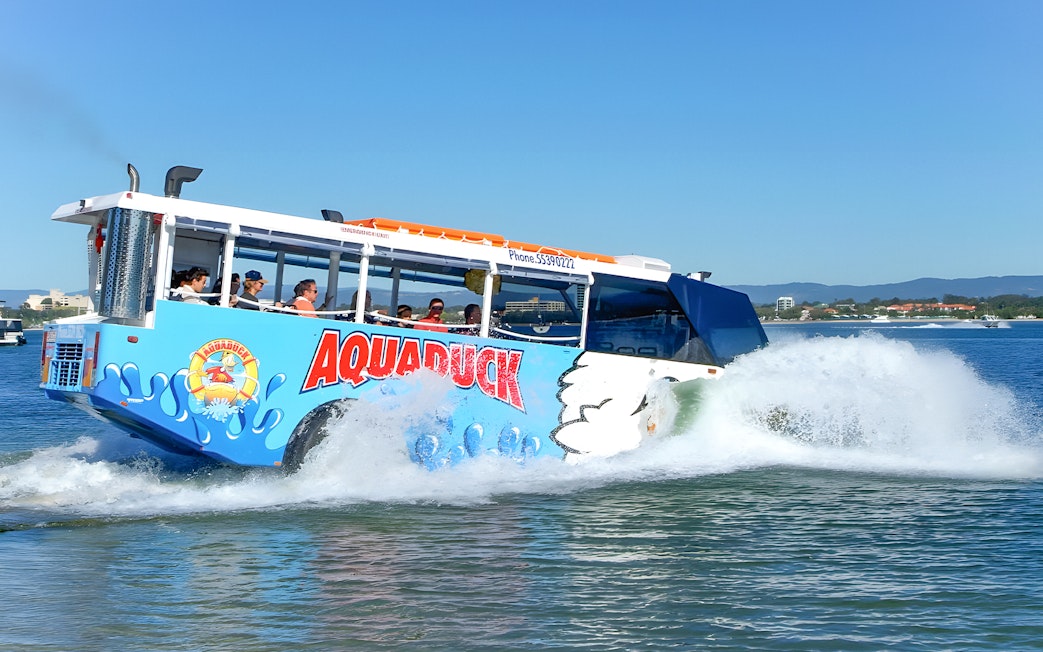 Aquaduck amphibious vehicle cruising on a river during a city tour.