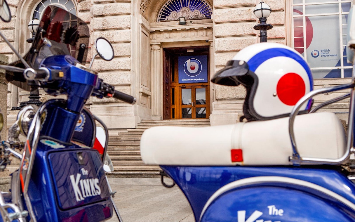 Scooter and helmet outside British Music Experience entrance in Liverpool.