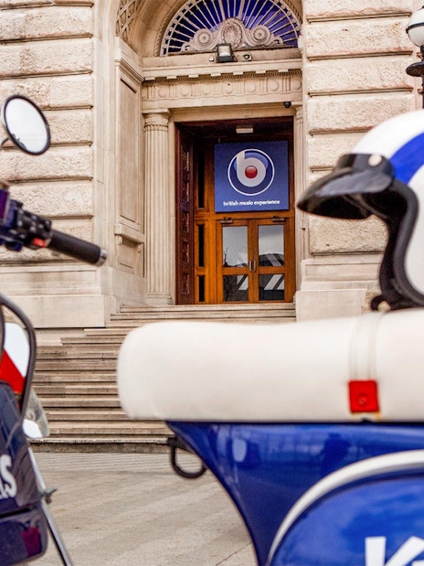 Scooter and helmet outside British Music Experience entrance in Liverpool.