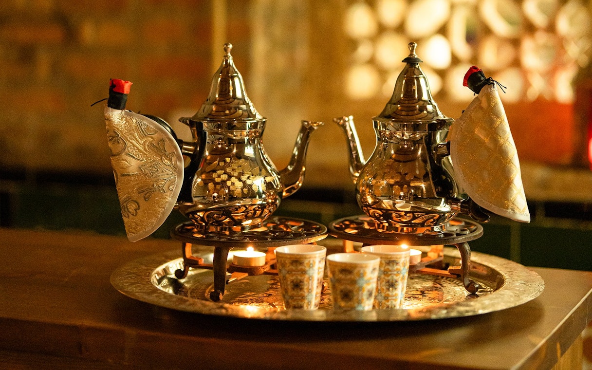 Traditional teapots and cups on a tray during a Hammam bath in Granada.