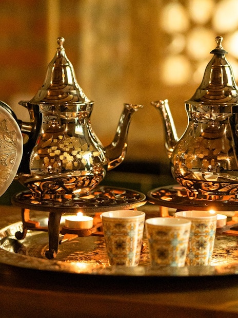 Traditional teapots and cups on a tray during a Hammam bath in Granada.