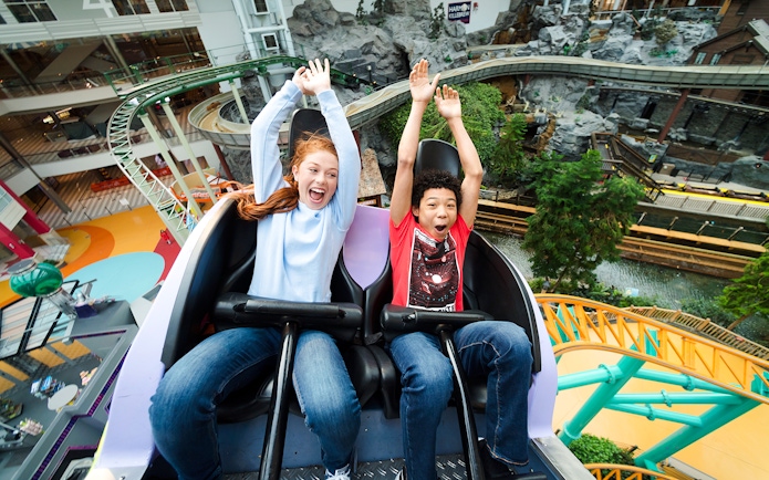 Guests enjoying a roller coaster ride at Nickelodeon Universe, Mall of America.