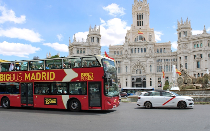 Big Bus tour passing Cibeles Palace and Fountain in Madrid.