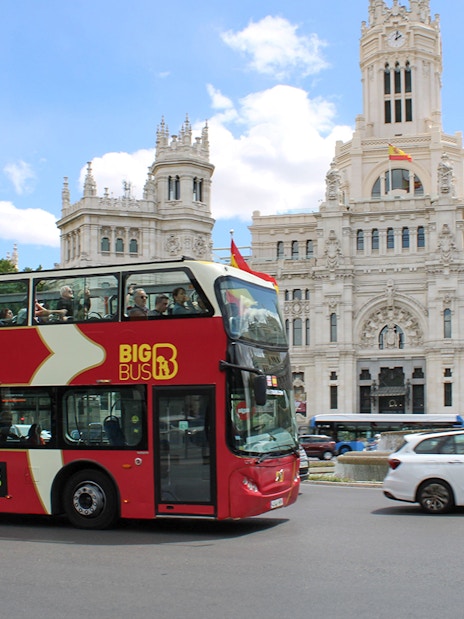 Big Bus tour passing Cibeles Palace and Fountain in Madrid.