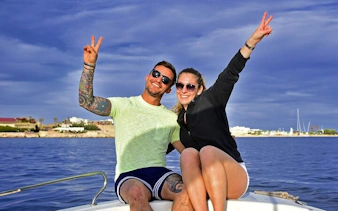 Couple enjoying a boat ride on the Red Sea before parasailing in Hurghada.