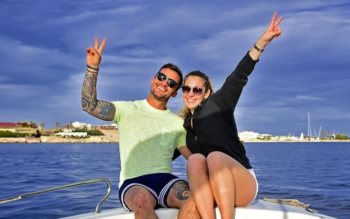 Couple enjoying a boat ride on the Red Sea before parasailing in Hurghada.