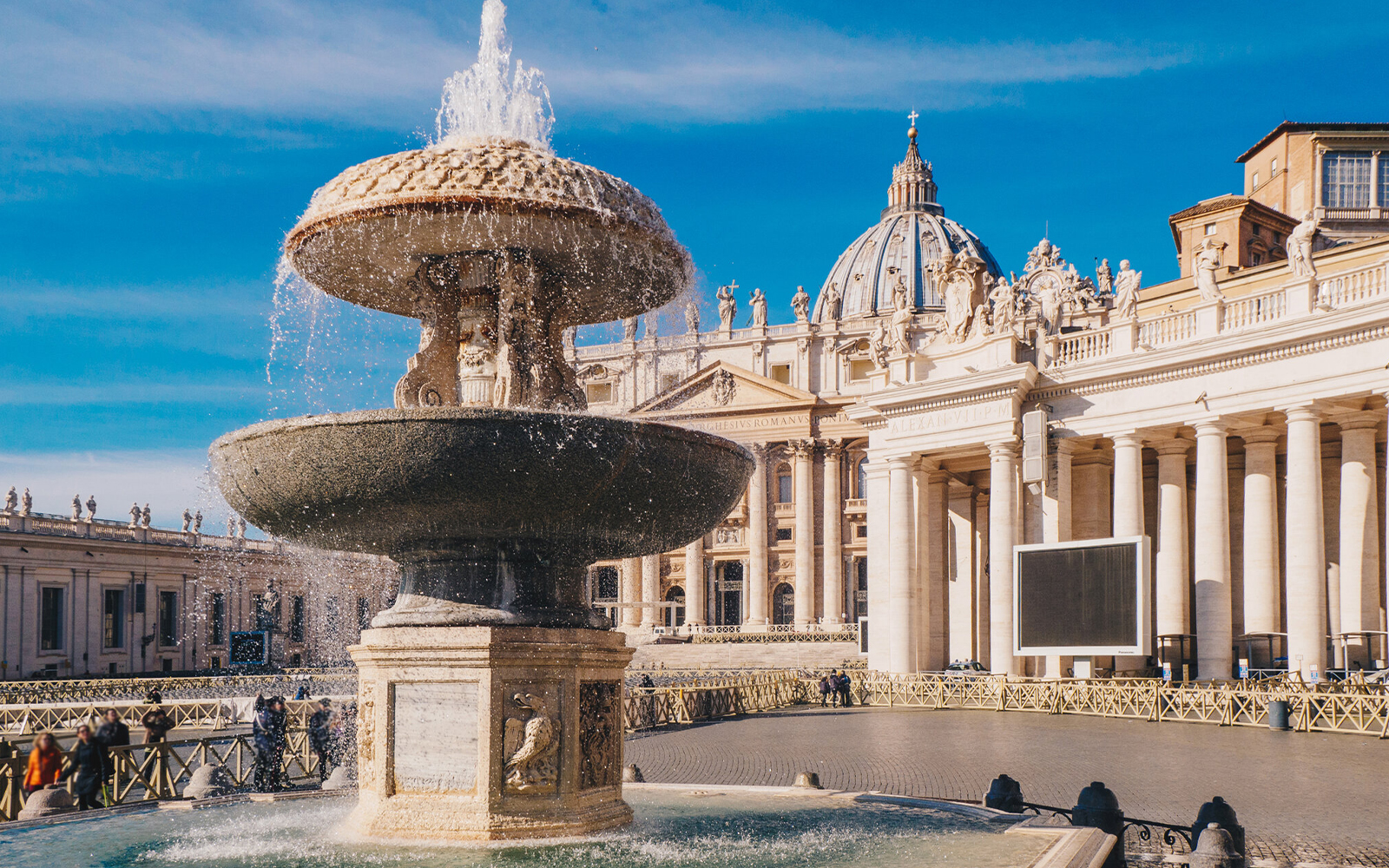 St. Peter's Basilica exterior with fountain in foreground, Vatican City.
