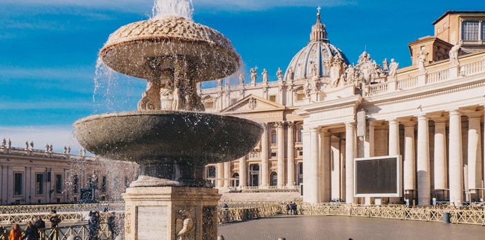 St. Peter's Basilica exterior with fountain in foreground, Vatican City.