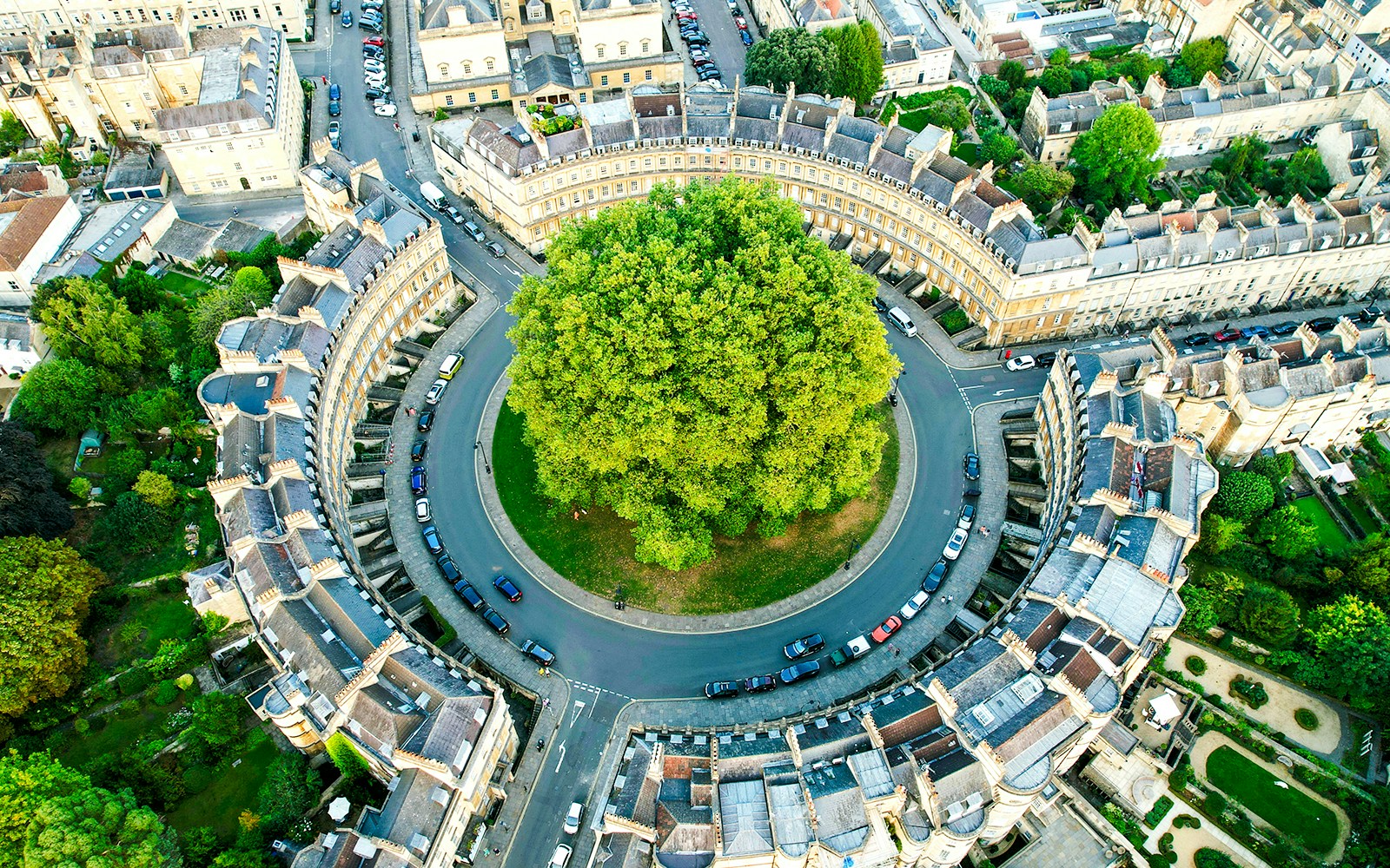 Aerial view of the Circus in Bath, UK, showcasing circular Georgian architecture and central green space.