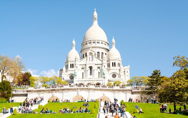 Elysée Montmartre concert hall exterior with people walking in Paris, France.