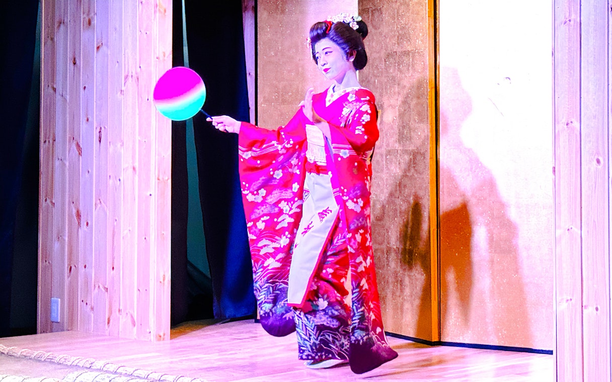 Performer in traditional attire during a Sumo Show Experience in Japan.