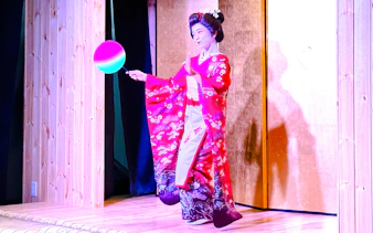 Performer in traditional attire during a Sumo Show Experience in Japan.