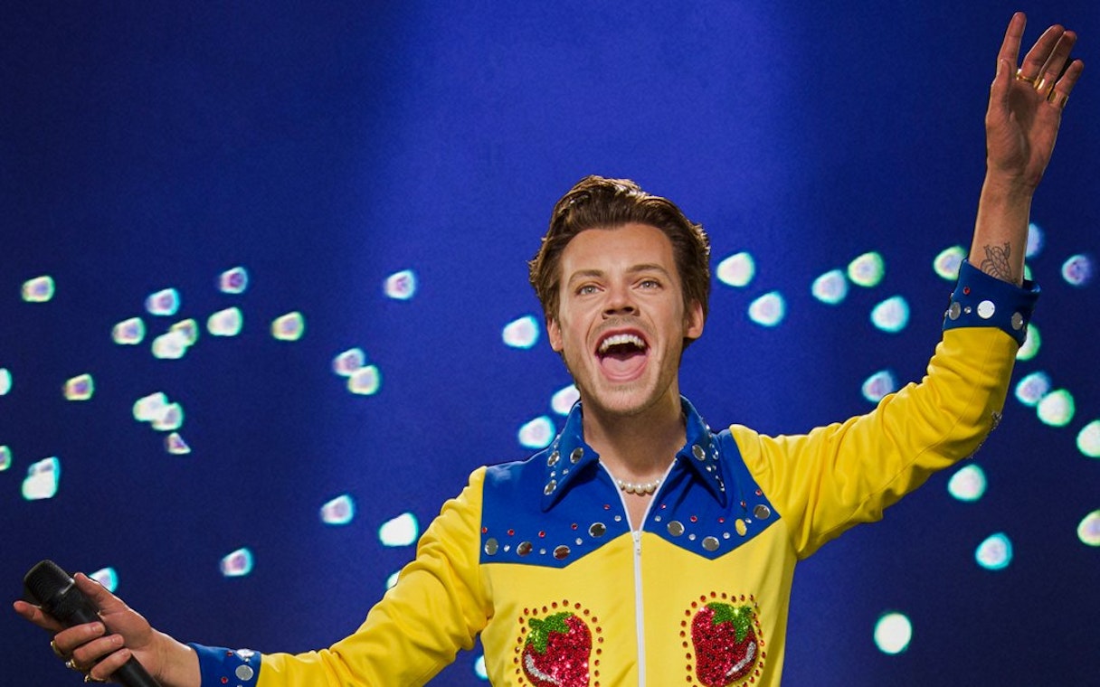 Wax figure of a performer in a colorful outfit at Madame Tussauds Singapore.