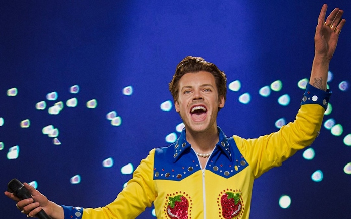 Wax figure of a performer in a colorful outfit at Madame Tussauds Singapore.