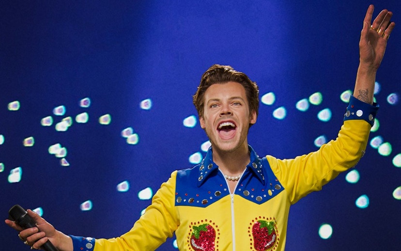 Wax figure of a performer in a colorful outfit at Madame Tussauds Singapore.