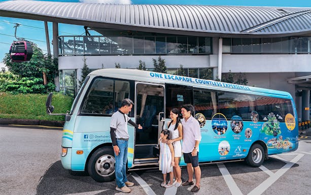 Family boarding tour bus at Singapore cable car station.