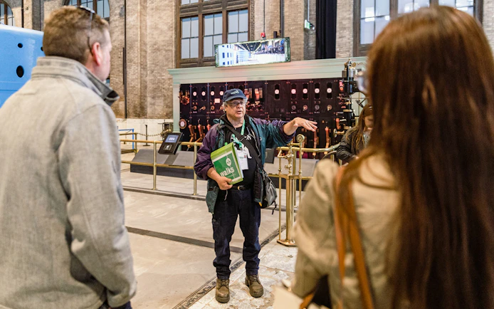 Guide explaining to tourists inside Niagara Power Station.