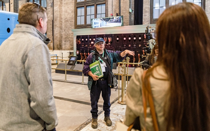 Guide explaining to tourists inside Niagara Power Station.