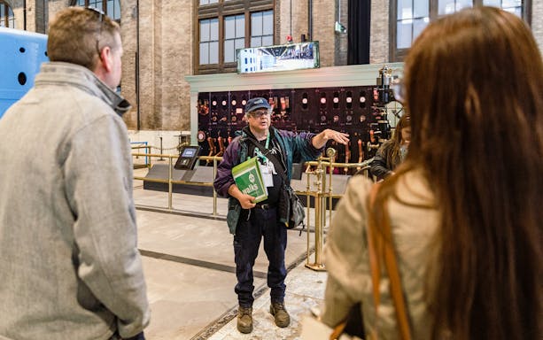 Guide explaining to tourists inside Niagara Power Station.