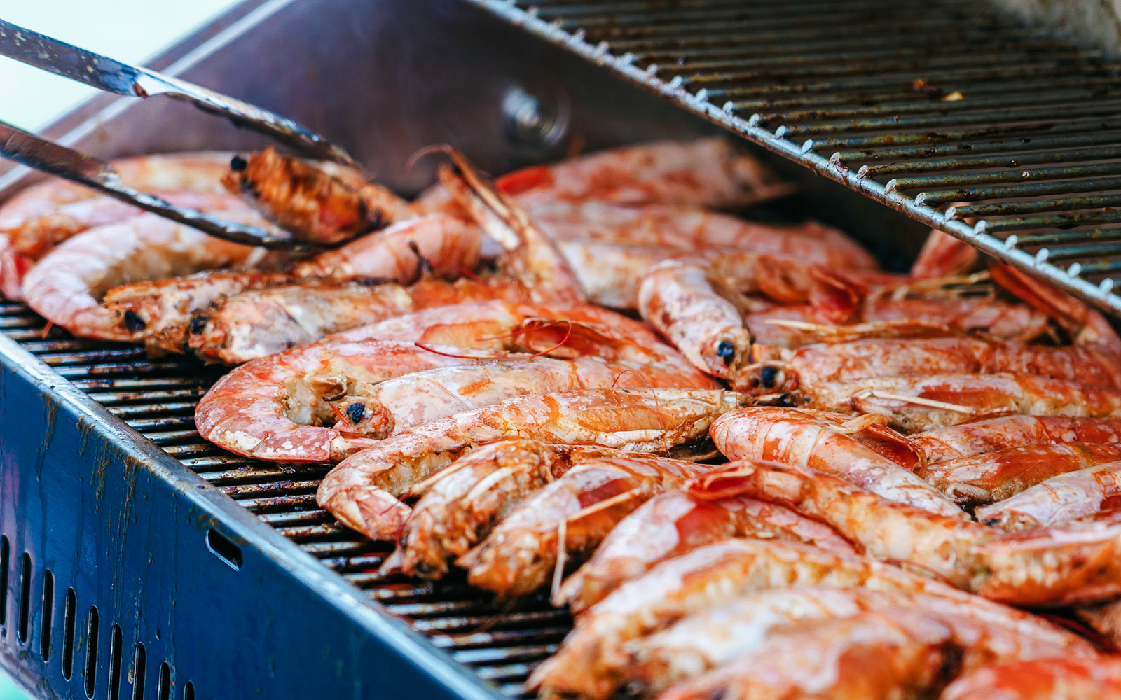 Grilled prawns on a barbecue during Santorini Premium Catamaran Cruise.