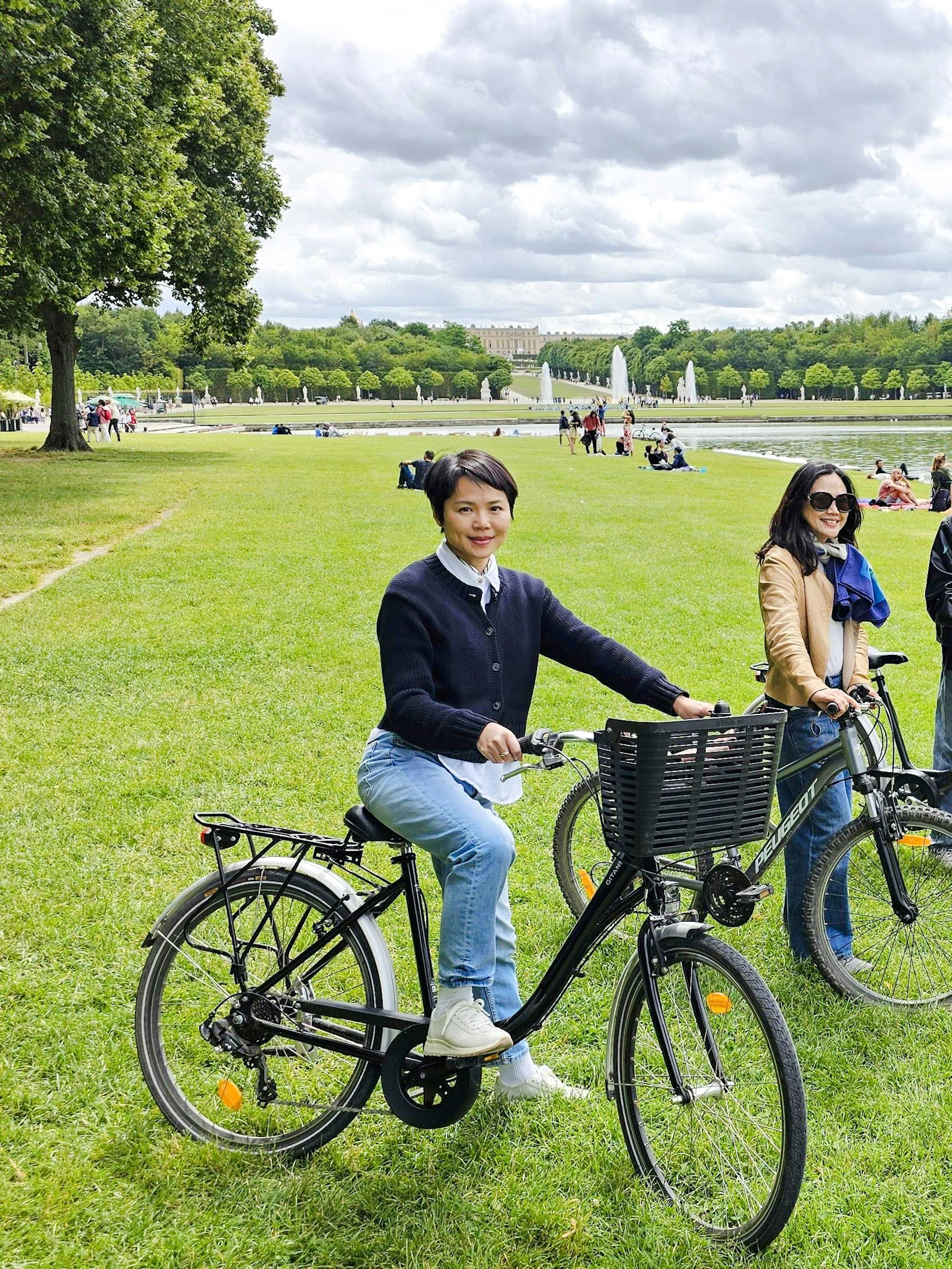 Visitors biking in the gardens of Versailles near the Grand Canal.