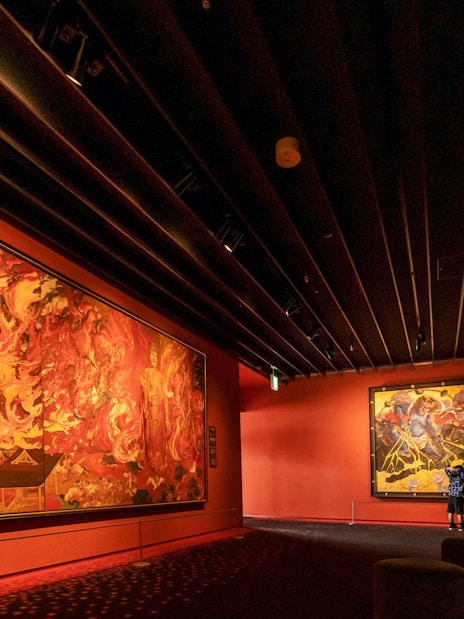 Visitors viewing vibrant murals at Osaka Koji Kinutani Tenku Art Museum.