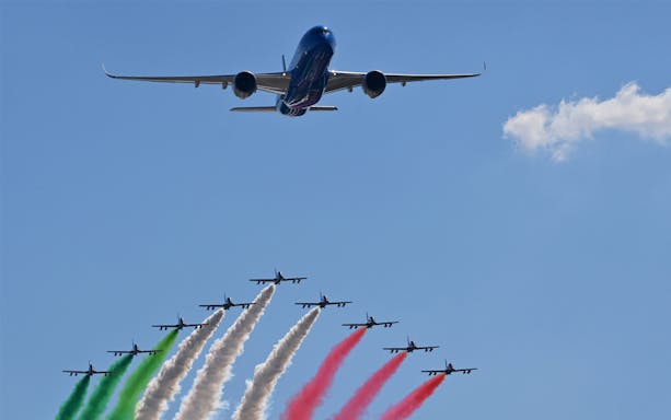 Airshow with planes displaying Italian flag colors at Monza Grand Prix 2023.