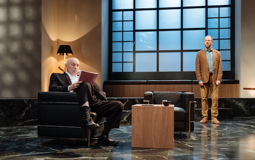 Two men in a modern theater set for the play "Bitter Wheat.