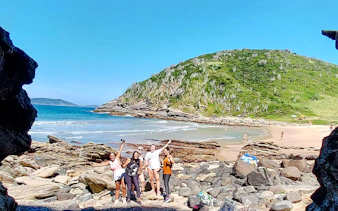 Group enjoying rocky beach at Emerências and José Gonçalves, Rio de Janeiro.