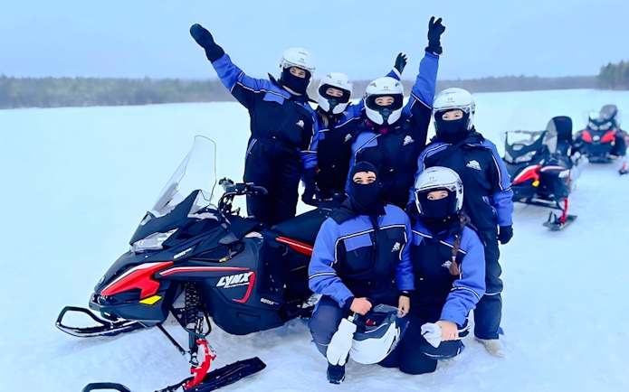Group on snowmobiles during Arctic safari in Rovaniemi.