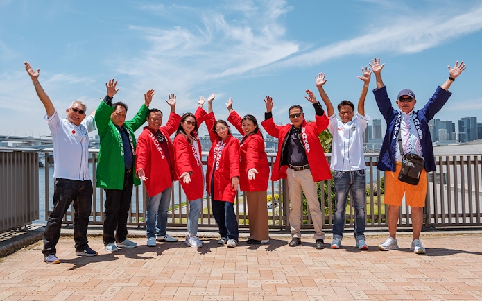 Group enjoying Asakusa 2-Hour Street GoKart Experience with city skyline in background.