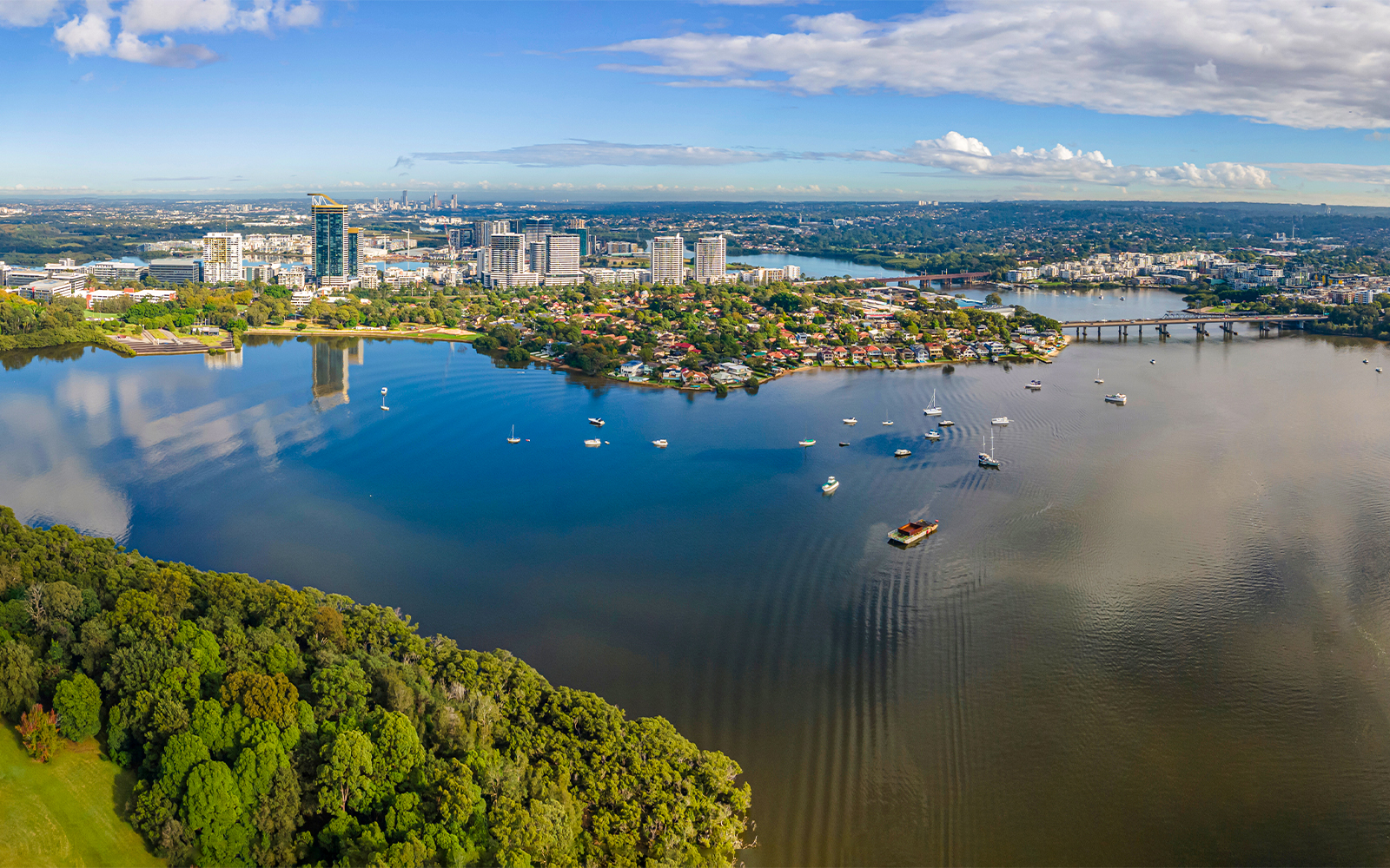 Sydney Harbour Bridge view from Parramatta River with city skyline in the background.