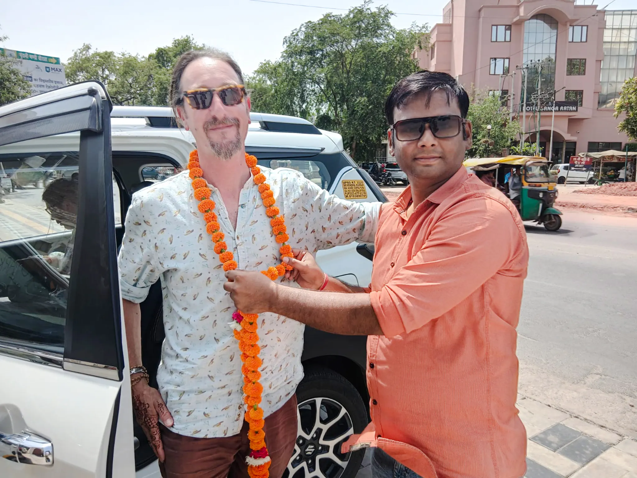 Tourist receiving a marigold garland from a guide in Agra during a private city tour.