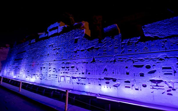 Karnak Temple hieroglyphs illuminated during Sound and Light show in Egypt.
