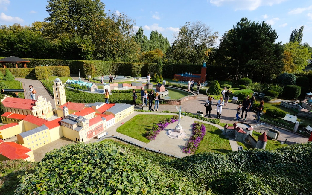 Tourists exploring miniature landmarks at Mini-Europe park in Brussels.