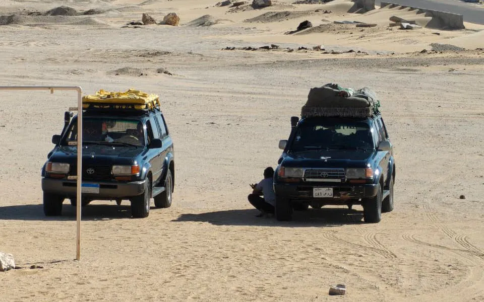 Two SUVs parked in the Black and White Desert during a private safari from Cairo.
